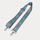 Grey ground with Light Blue Flower Print bag strap with silver metal clasps on light grey background