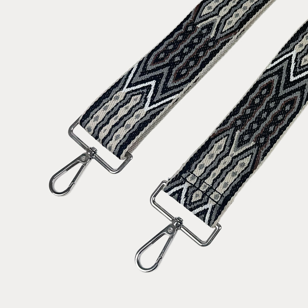 Black, Brown, Grey patterned strap with silver hardware on a light grey background