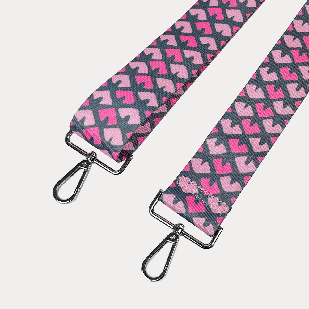 Pink & Grey Patterned strap with silver hardware on a light gray background