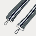 Grey, White, and Navy striped bag strap with silver hardware light gray background