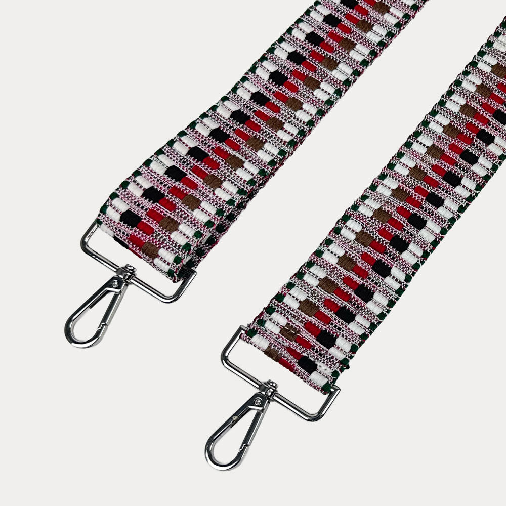 White, Black, Cranberry Multi Embroidered Patterned bag strap with silver hardware on a light gray background