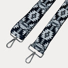 Black and white patterned strap with sliver hardware on a light gray background