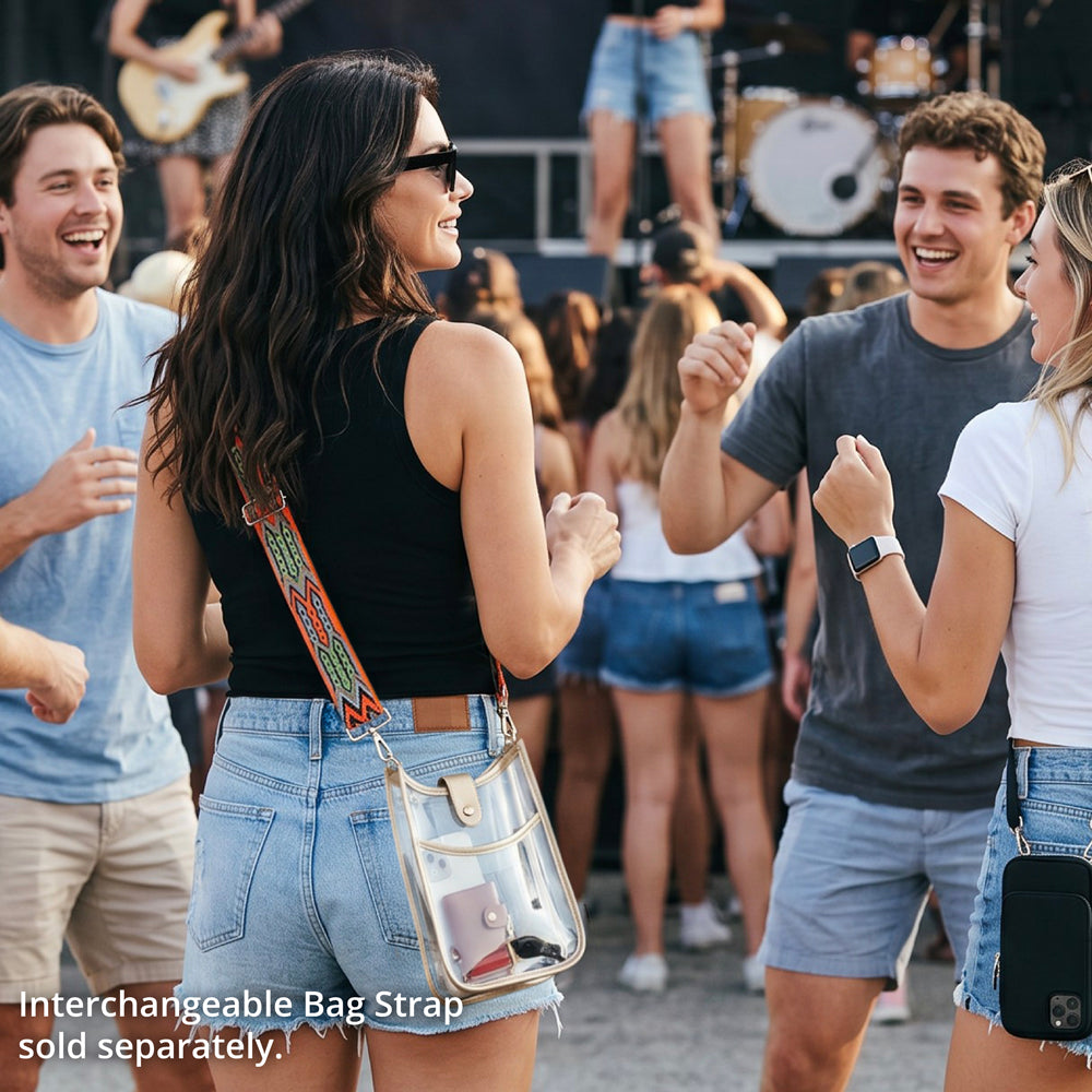 Woman at an outdoor concert, wearing a clear messenger bag and patterned bag strap. 