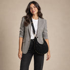Woman wearing a Vegan Suede Studded Crossbody Bag in Black