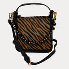 Handbag with zebra pattern vegan suede and black vegan leather details on a beige background