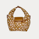 Handbag with deer print and camel leather accents on a light gray background- Back View