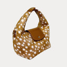 Handbag with deer print and camel leather accents on a light gray background- Side View