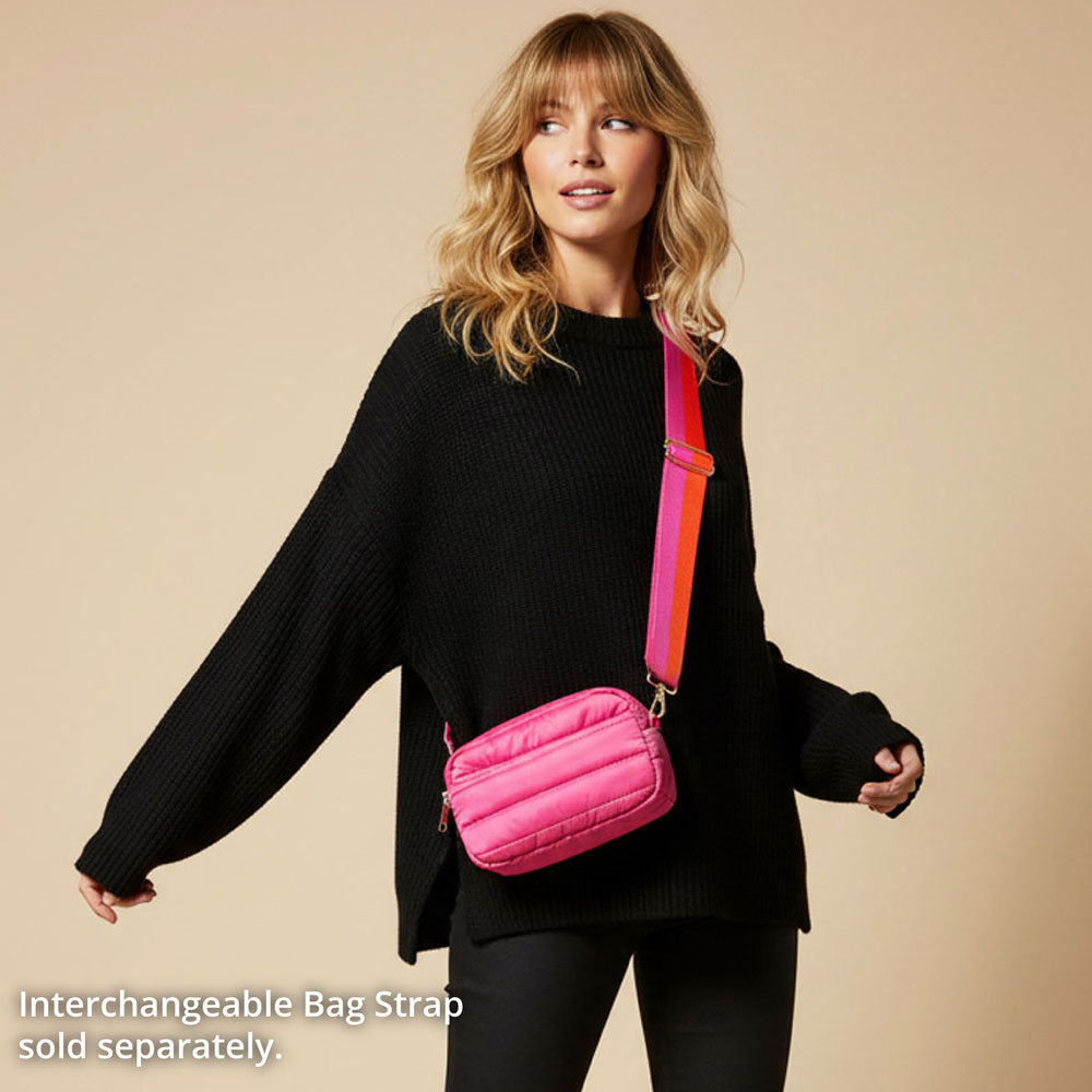 Woman wearing a black outfit with a pink bag on a beige background