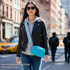 Woman wearing a turquoise bag on a city street