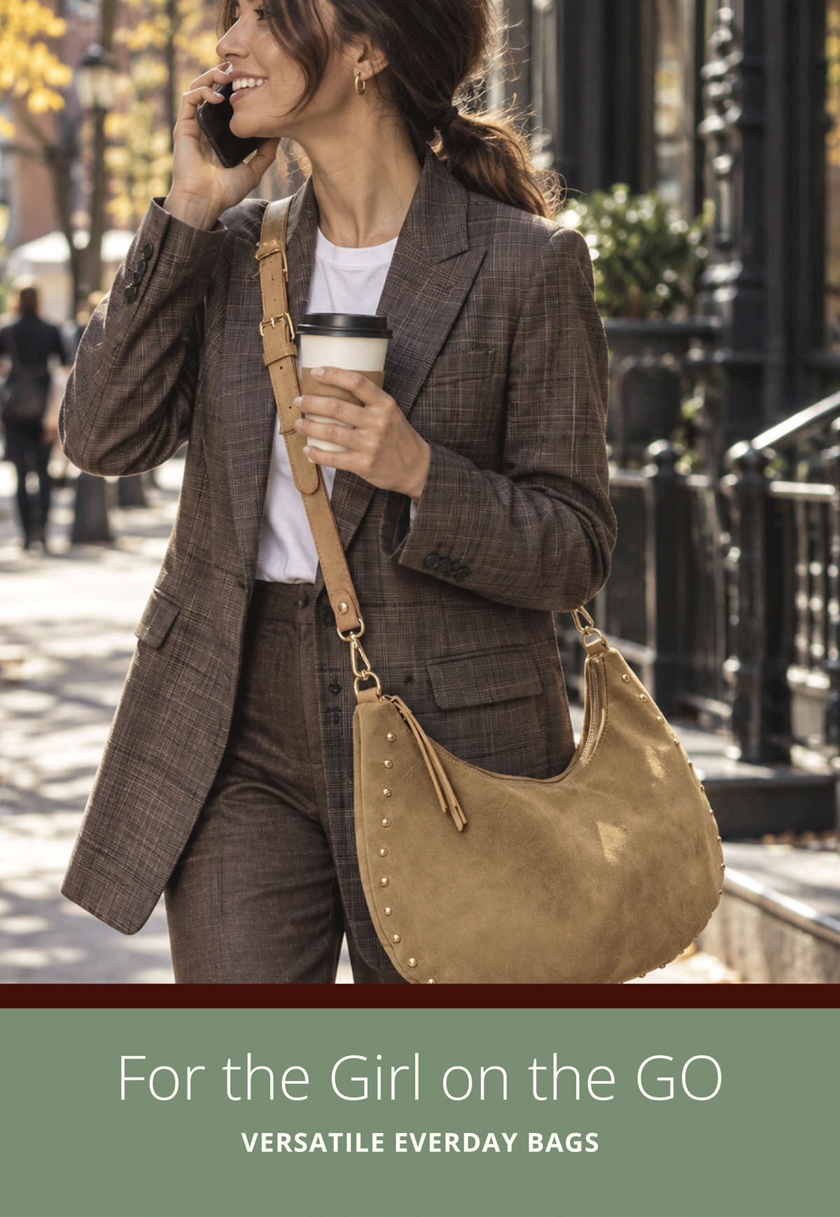 For the Girl on the Go. Versatile Everyday Bags.  Woman outside in the city, talking on the phone, wearing a crossbody suede bag. 