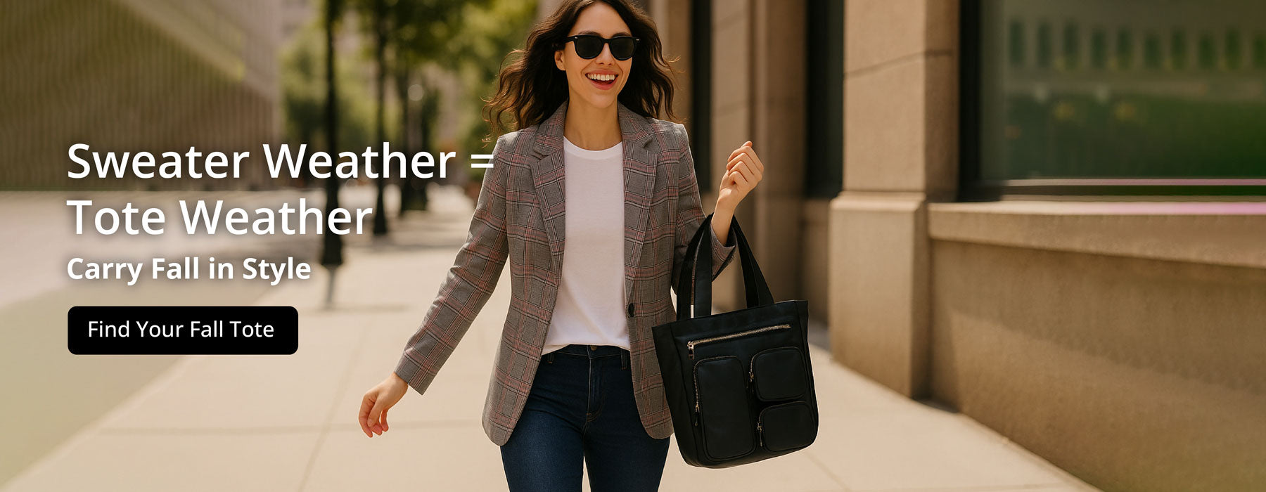 Woman walking with a black Jessie tote bag on a sidewalk, promoting fall fashion. Text: Sweater Weather = Tote Weather. Carry Fall in Style. Button: Find your Fall Tote. 