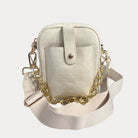 Cream handbag with gold chain strap on a light gray background