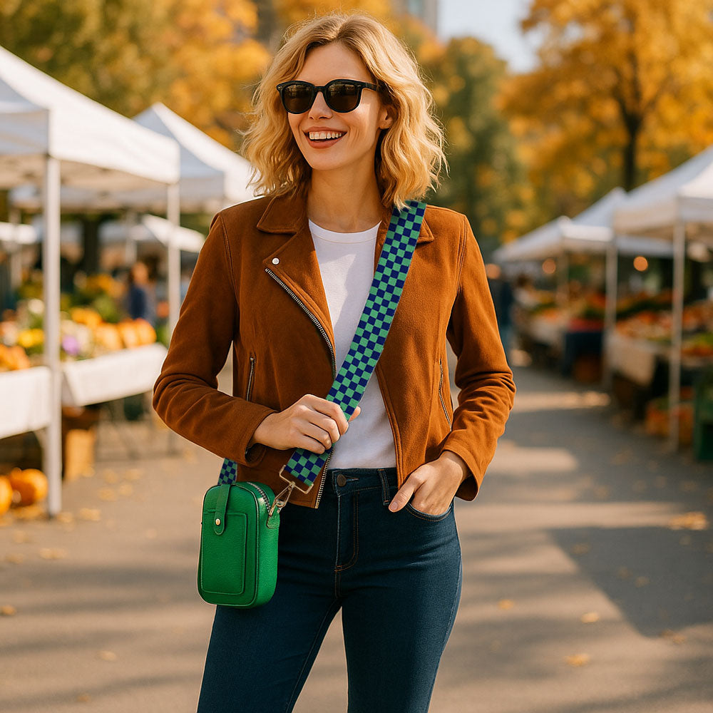 Woman in a brown jacket with a green bag at an outdoor market.