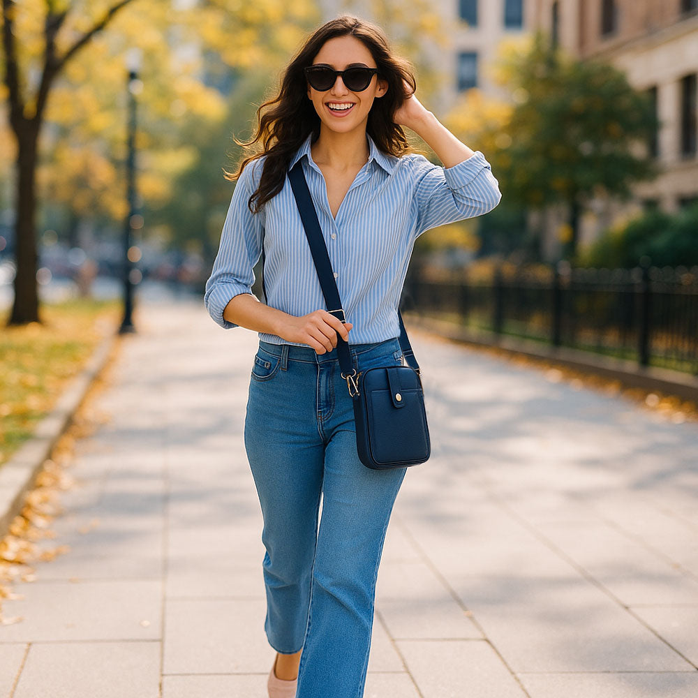 Woman walking in the park, wearing a navy crossbody bag