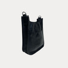 Side view of the Mini Vegan Leather Messenger in Black with Silver Hardware on grey background