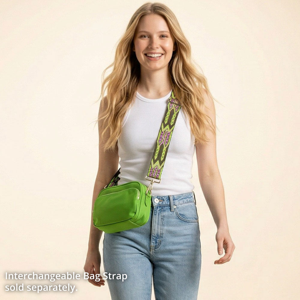 Woman wearing a green bag with an interchangeable strap on a beige background
