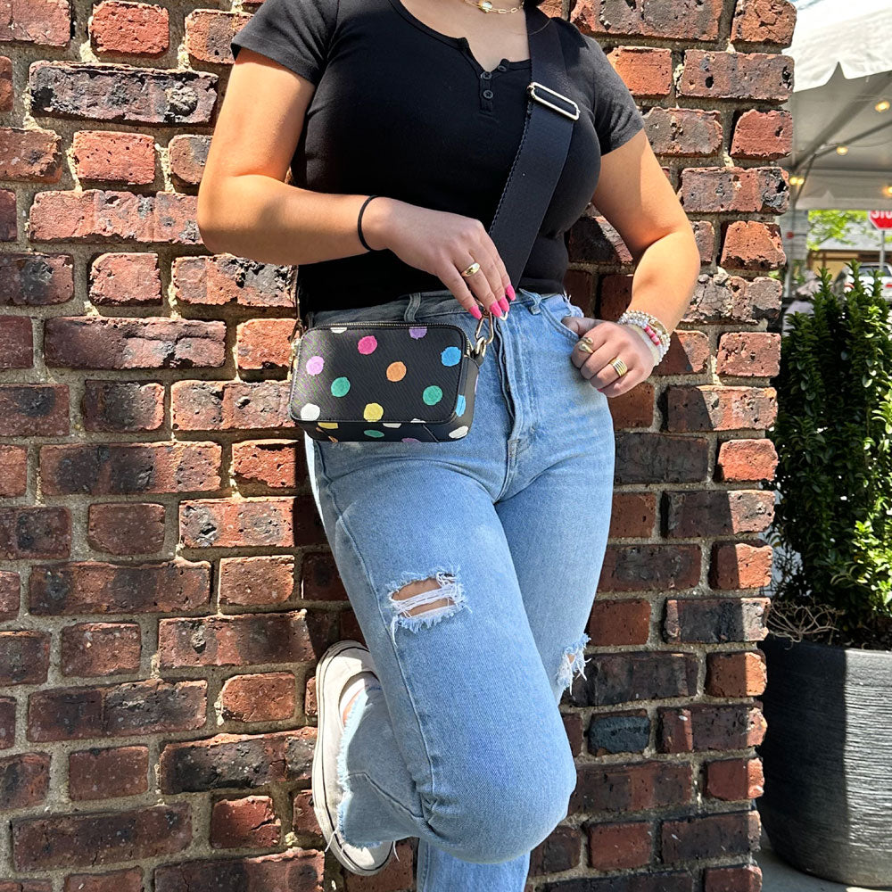 Woman wearing the Jamie Polka Dot Vegan Leather Crossbody in Black with Bright Dots