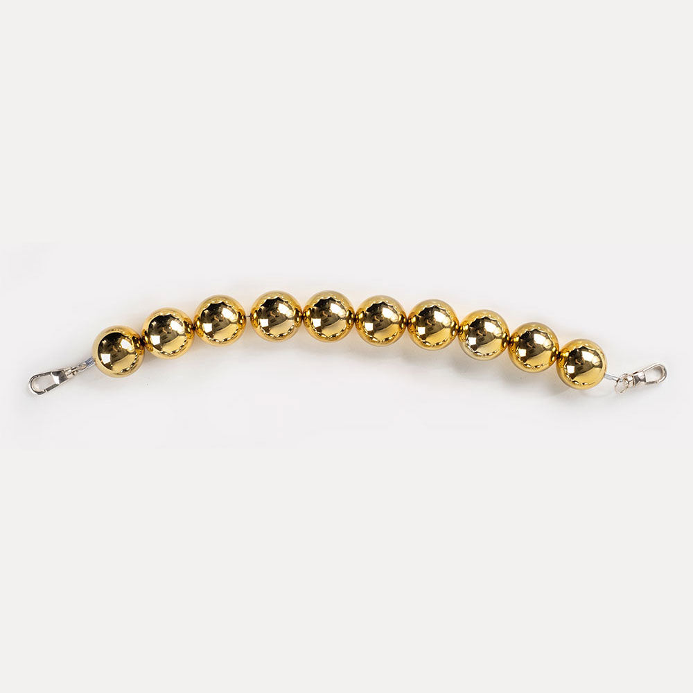 A gold-colored resin bead bag strap.