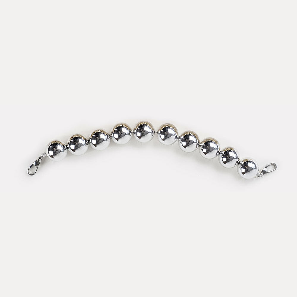 A silver-colored resin bead bag strap.