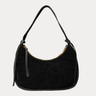 Black vegan suede handbag on a light gray background