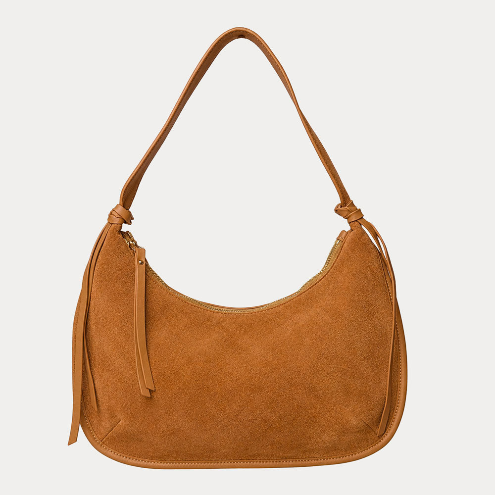 Camel vegan suede handbag on a light gray background