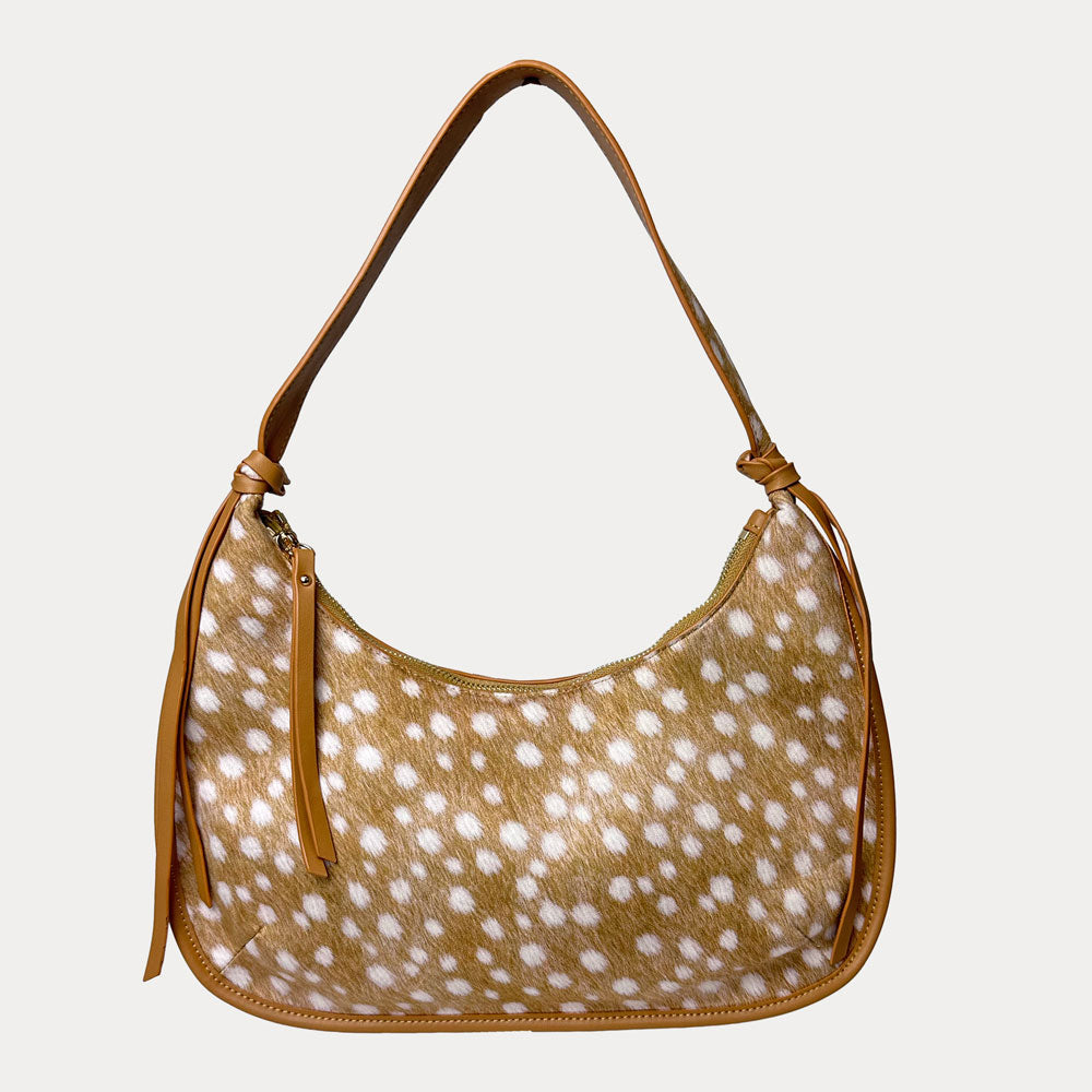 Handbag with deer pattern vegan suede and camel vegan leather details on a beige background