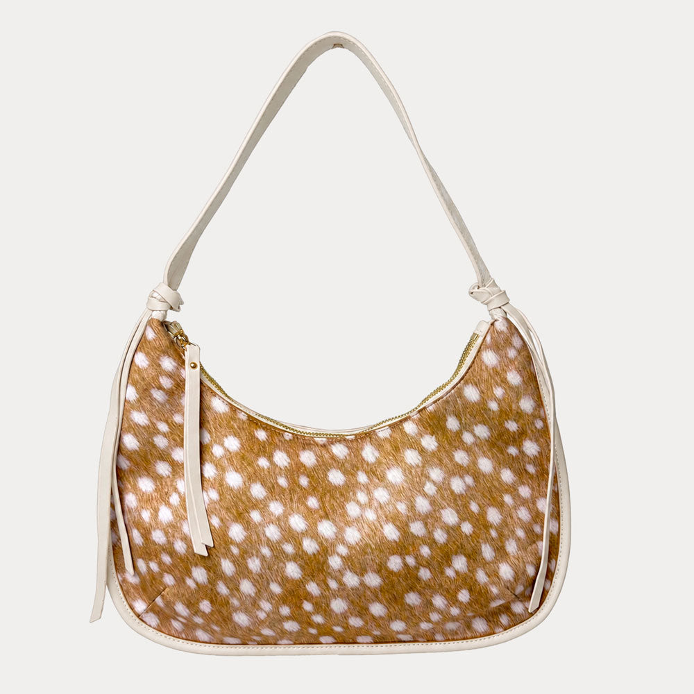 Handbag with deer pattern vegan suede and cream vegan leather details on a beige background