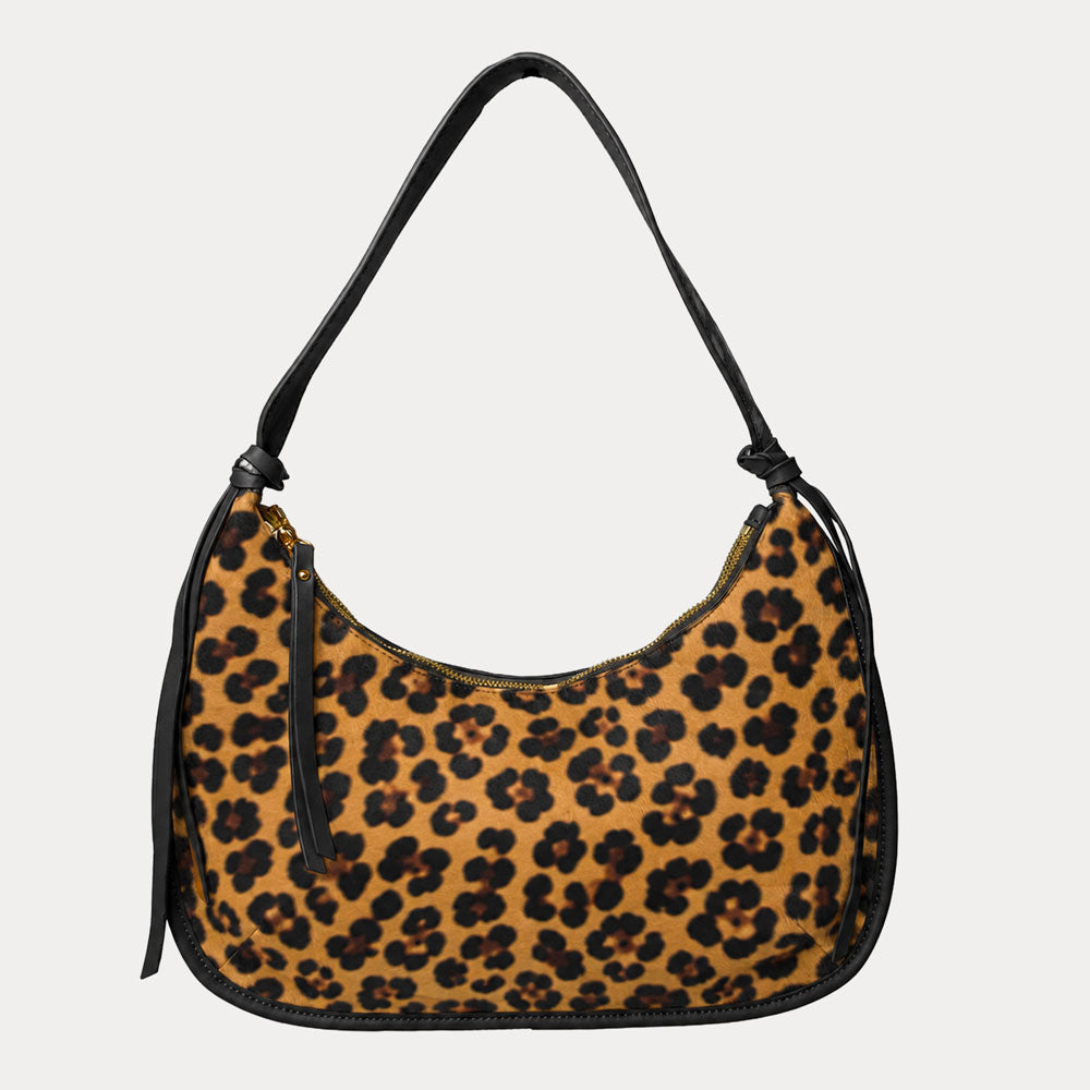 Handbag with leopard pattern vegan suede and black vegan leather details on a beige background