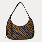 Handbag with zebra pattern vegan suede and black vegan leather details on a beige background