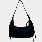 A black leather shoulder bag with a vegan leather shoulder strap, shown against a plain light gray background.