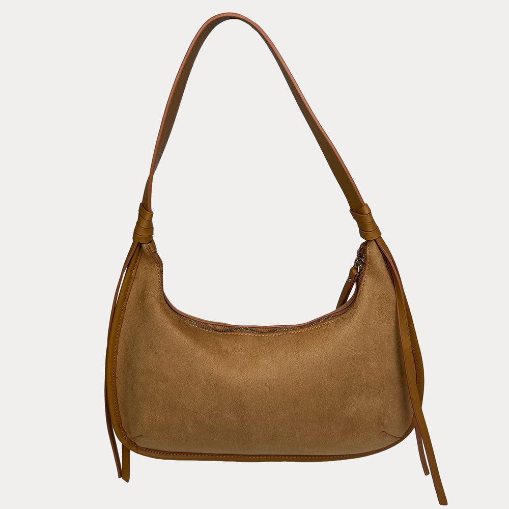 A camel vegan suede shoulder bag with a shoulder strap and long fringe details on the sides, shown against a light gray background.