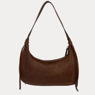 A chocolate shoulder bag with a strap and decorative side tassels, shown against a light gray background.