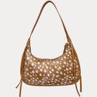 A shoulder bag with a deer animal-print body and camel vegan leather strap, shown against a light gray background.