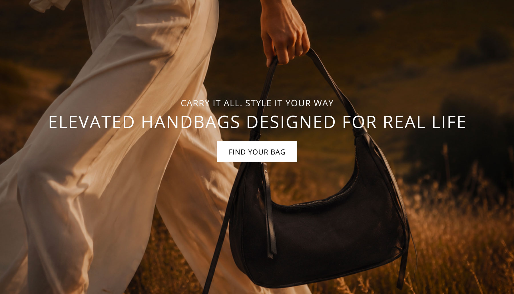 A person in white clothing walks through a sunlit field while carrying a black shoulder handbag. Large overlaid text reads 'ELEVATED HANDBAGS DESIGNED FOR REAL LIFE' with a 'FIND YOUR BAG' button.