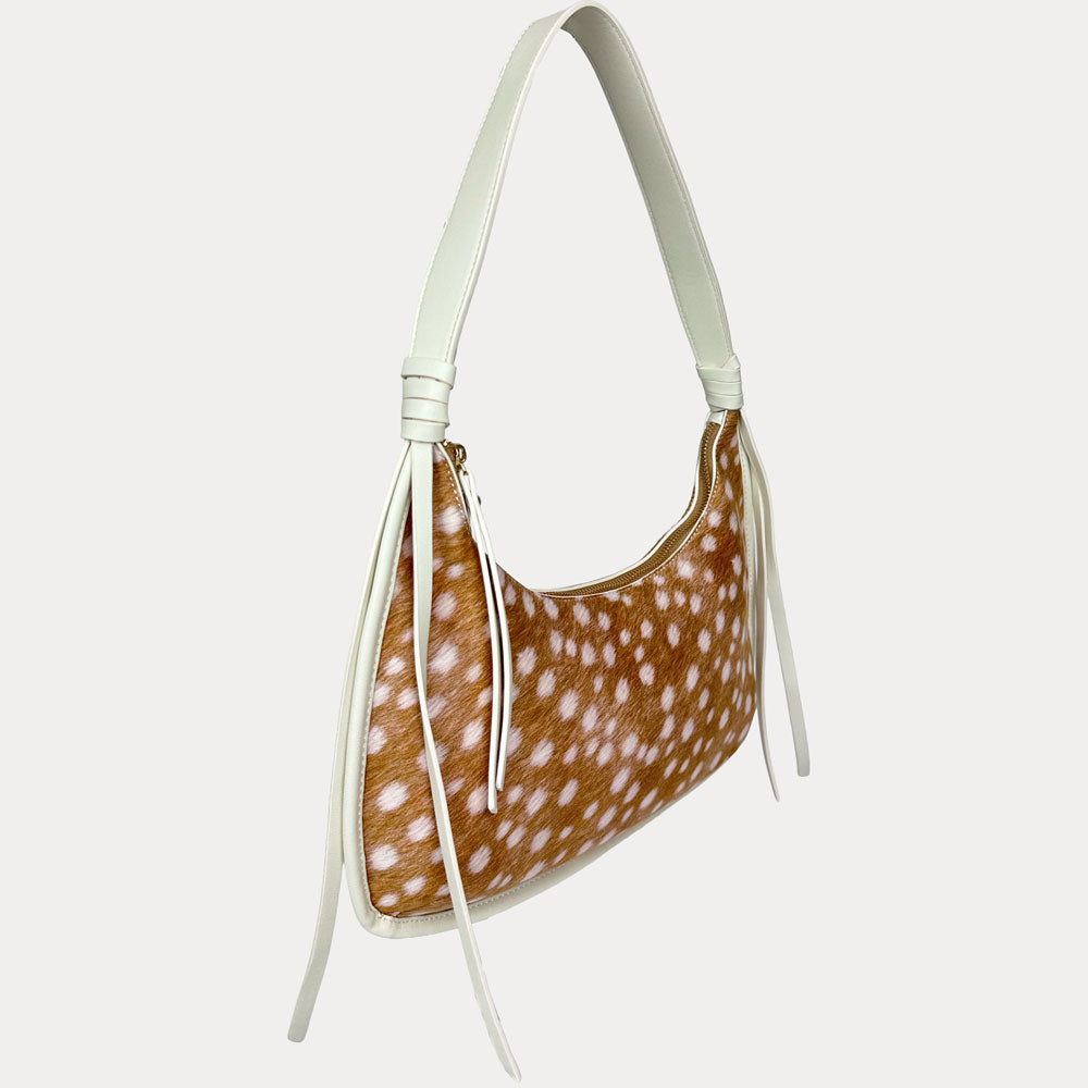 A shoulder bag with a deer animal print body and a solid cream strap, shown against a light gray background.