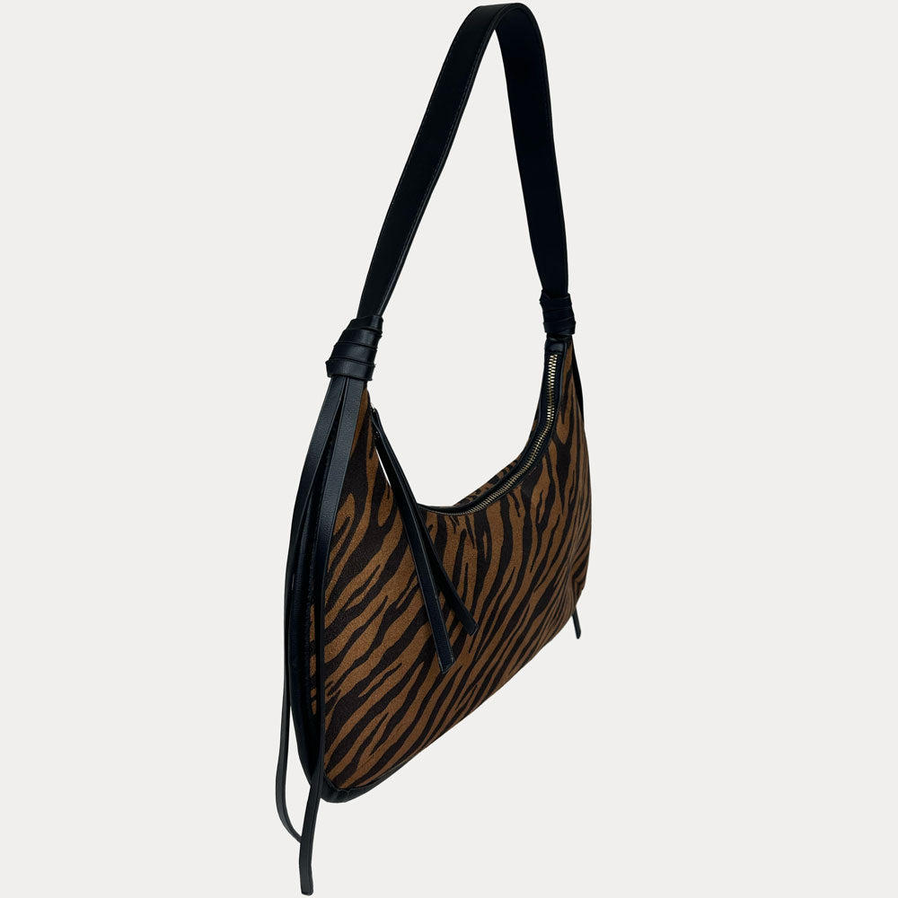 A shoulder bag with a brown and black tiger stripe pattern, featuring black vegan leather trim, shown against a light gray background.