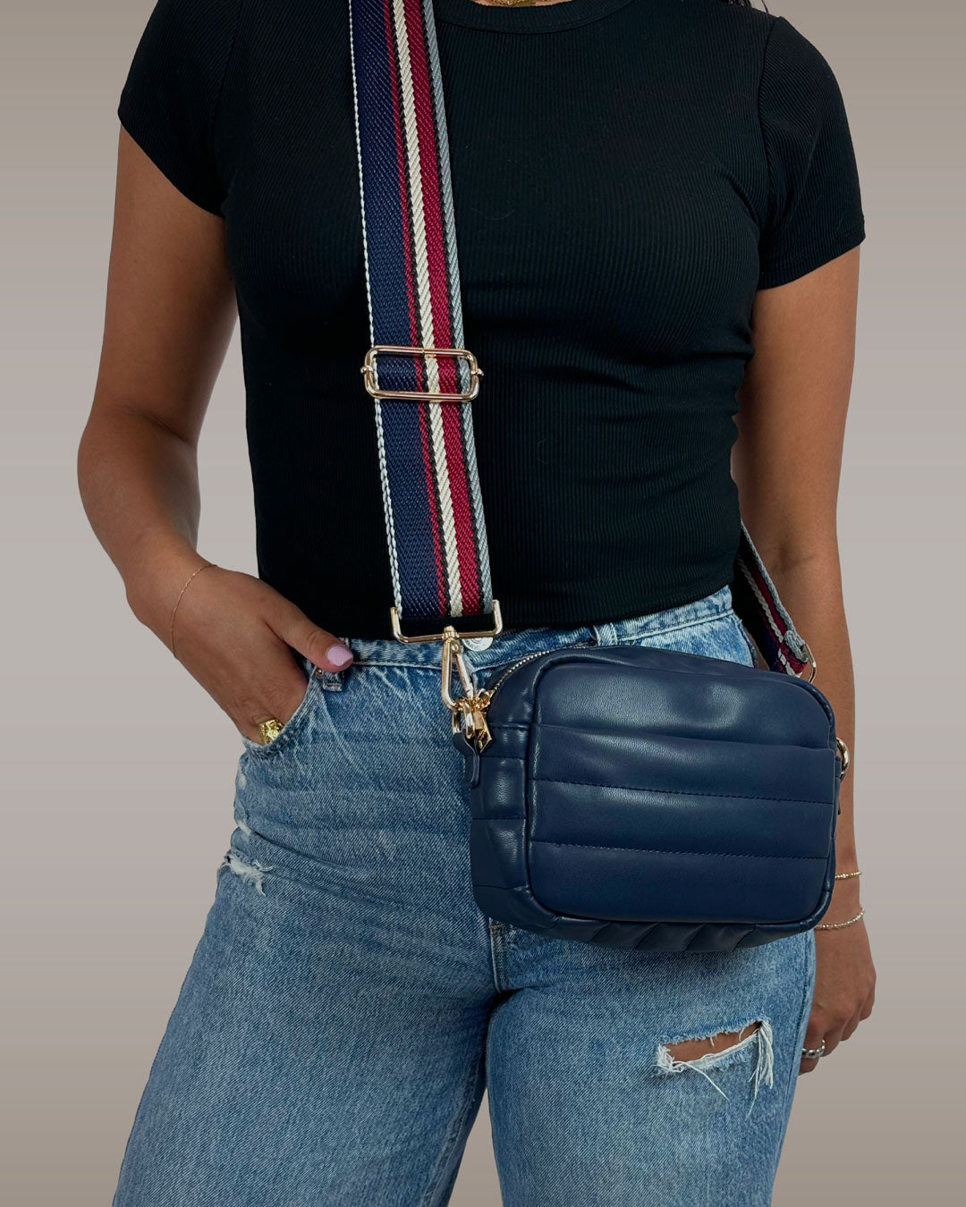 Image of a Woman wearing the Sadie Quilted Vegan Leather crossbody bag in navy
