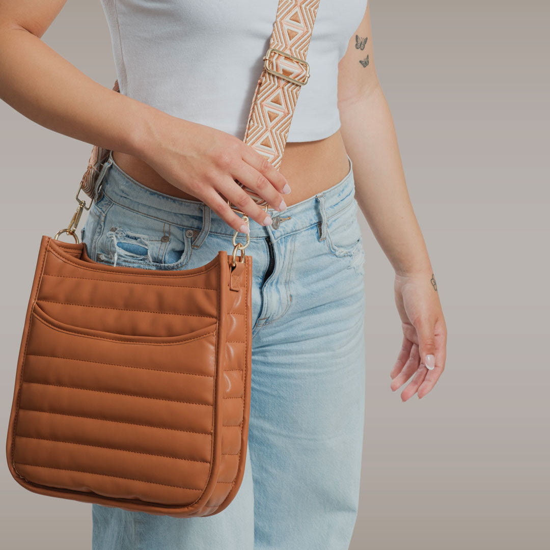 Image of a Woman wearing the Sarah Quilted Vegan Leather Messenger bag in Camel